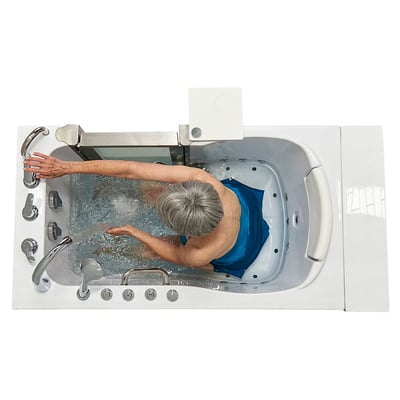 Overhead view of senior woman soaking in an Ella Elite walk-in tub with hydro jets and bubbling water visible from above