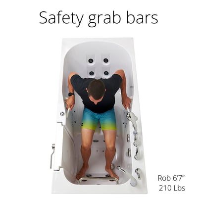 Overhead view of man gripping safety grab bars inside an Ella walk-in tub with anti-slip floor and hydro jets