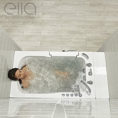 Woman relaxing with eyes closed enjoying a hydro massage in the Ella Monaco walk-in bathtub viewed from above