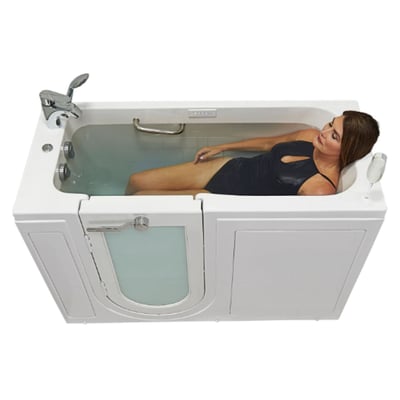 Woman reclining and soaking in an Ella lounger walk-in tub with outward swing door, jets, and chrome faucet