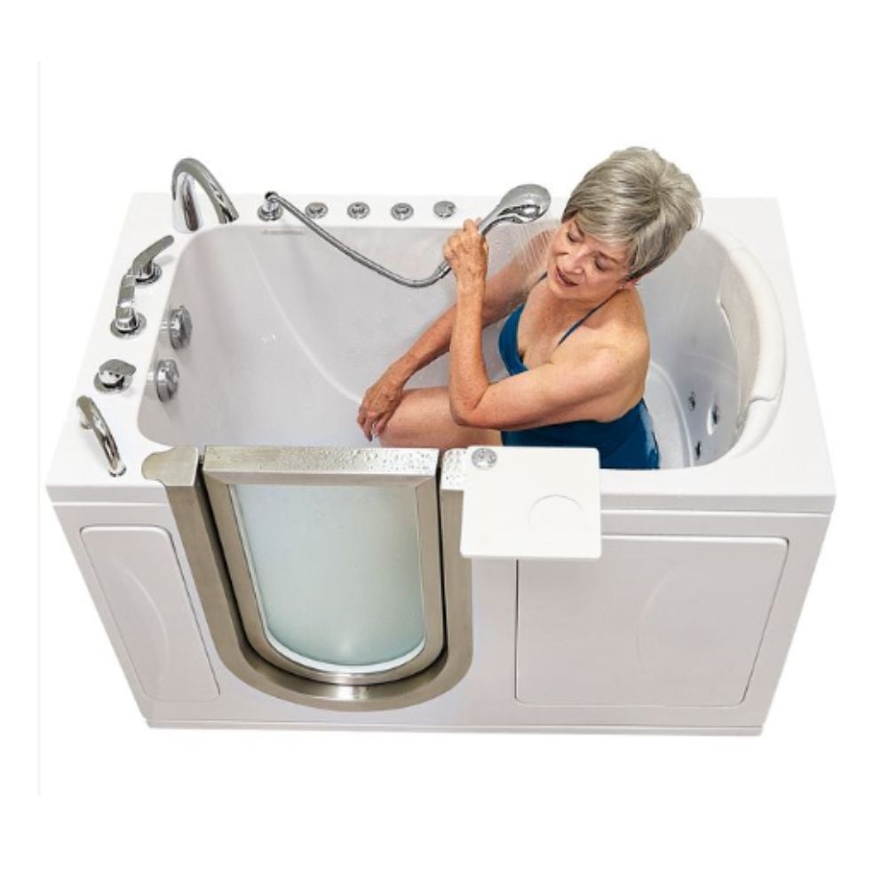 Senior woman seated in Ella petite walk-in tub using handheld showerhead with hydro jets and low-step door entry