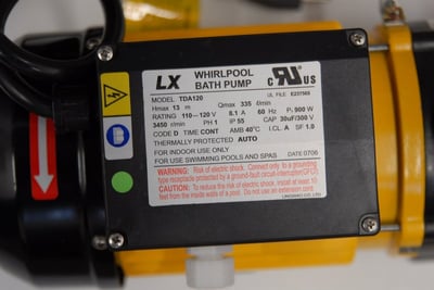 Close-up of LX whirlpool bath pump model TDA120 motor with UL-listed label showing 900W power specs