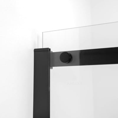 Gros plan de la quincaillerie noir mat d’une porte de douche coulissante en verre trempé avec détail de poignée bouton ronde