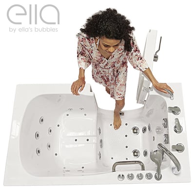Woman in floral robe stepping into the Ella Capri walk-in tub with outward swing door, jets, and anti-slip floor