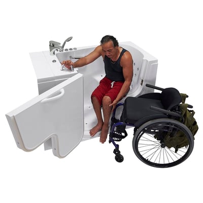 Person transferring from his chair into the Ella Transfer26 walk-in tub with outward swing door open wide for easy access