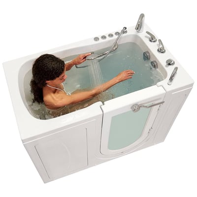 Woman using a handheld showerhead while soaking in the Ella Monaco walk-in tub with outward swing door and hydro jets