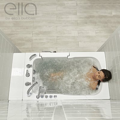 Woman relaxing with eyes closed during a hydro massage in the Ella Monaco walk-in bathtub seen from overhead