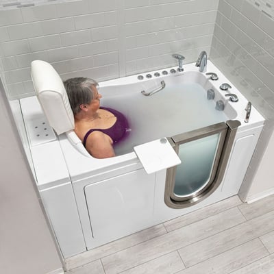 Senior woman relaxing in an Ella walk-in tub with a white removable padded headrest and neck support pillow
