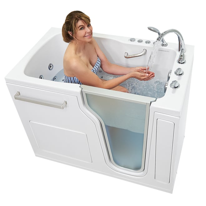 Woman smiling and cupping running water from the faucet inside an Ella Ultra walk-in tub with hydro jets active