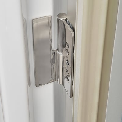 Close-up of a polished stainless steel door hinge on the Ella Ultra walk-in tub watertight door frame