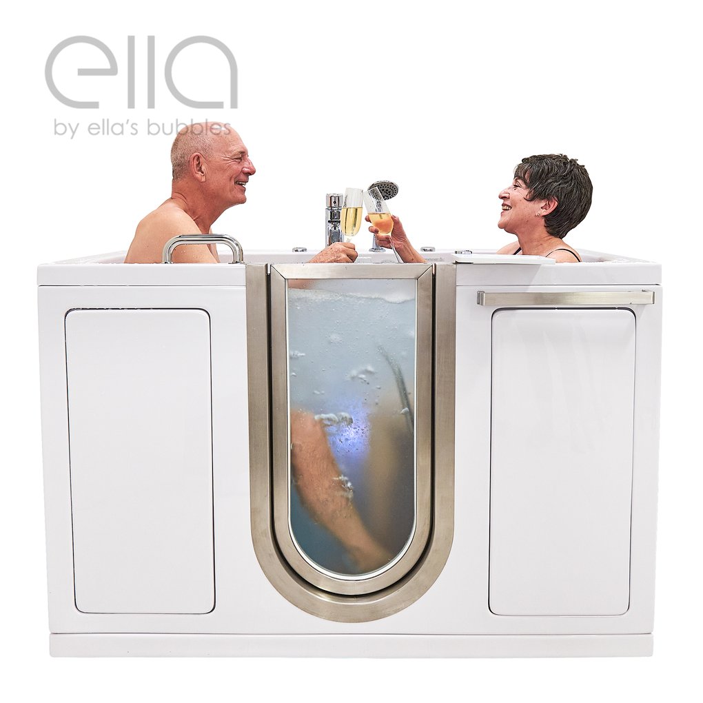 Senior couple smiling and toasting with champagne while soaking in the Ella Companion two-seat walk-in tub with clear door panel