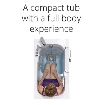 Overhead view of a senior woman soaking in the Ella Mobile compact walk-in tub showing full body fit in the 26x45 inch basin