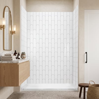 Bamboo arch pattern acrylic shower wall panels in a beige bathroom with a floating oak vanity and arched mirror