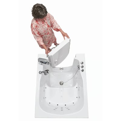 Senior woman opening the outward swing front entry door on an Ella walk-in tub with hydro jets, viewed from above