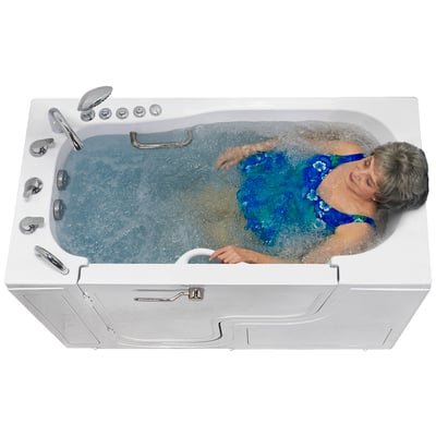 Woman in a blue swimsuit soaking in the bubbling hydrotherapy water of an Ella walk in tub
