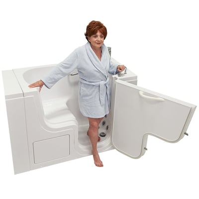 Senior woman in a light blue robe stepping out of the Ella Transfer30 ADA accessible walk-in bathtub with outswing door open