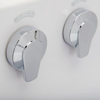 Close-up of two chrome lever faucet controls on the Ella Royal walk-in tub with OFF-ON directional labels