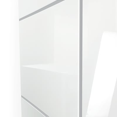 Close-up of white acrylic subway shower wall panels with gray grout lines and a built-in corner shelf