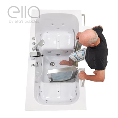 Senior man stepping into the Ella Companion two-person walk-in tub through the wide door with dual drain and hydro jets