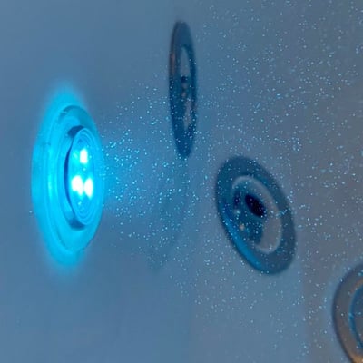 Close-up of a glowing blue LED chromotherapy light on the interior wall of an Ella walk-in tub