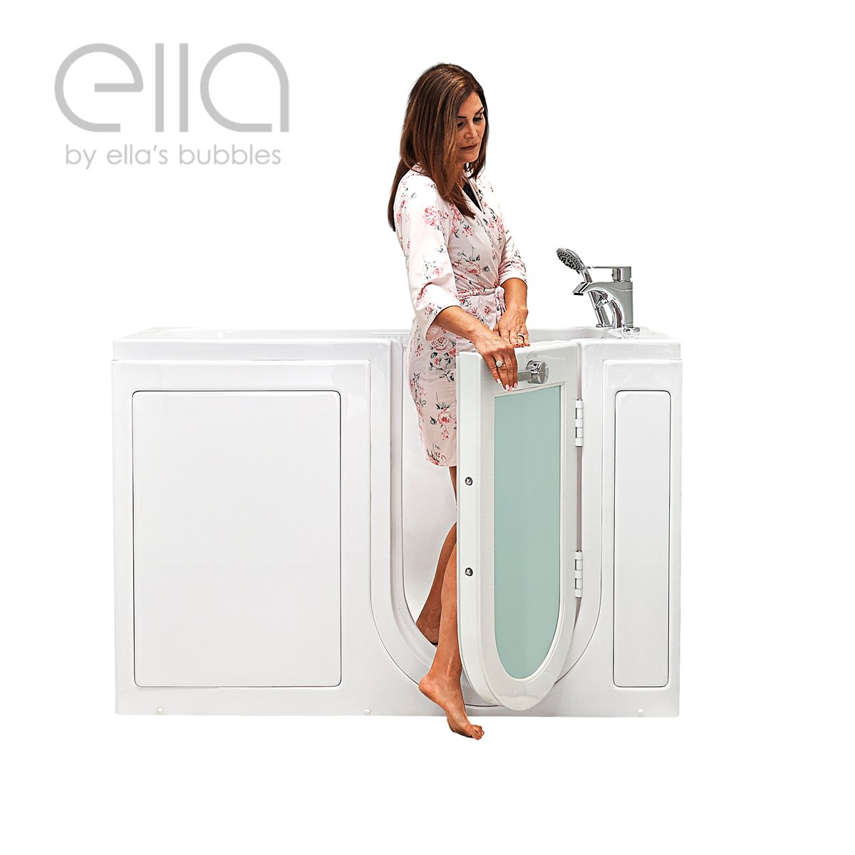 Woman in a floral robe stepping into the Ella Lounger walk-in tub through the outward swing glass door