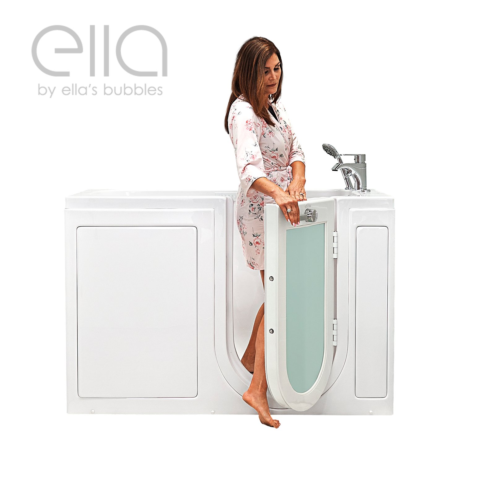 Woman in floral robe stepping into an Ella's Bubbles lounger walk-in tub with outward swing glass door open