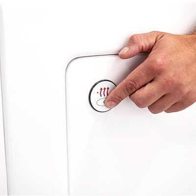 Close-up of a hand pressing the heated seat control button on the white wall panel of an Ella walk-in tub