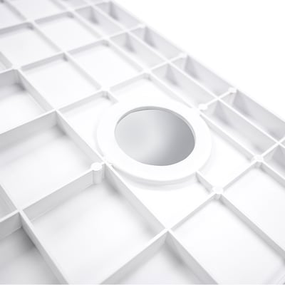 Close-up of white SMC ADA shower pan base with grid anti-slip texture and centered chrome drain for accessible bathrooms