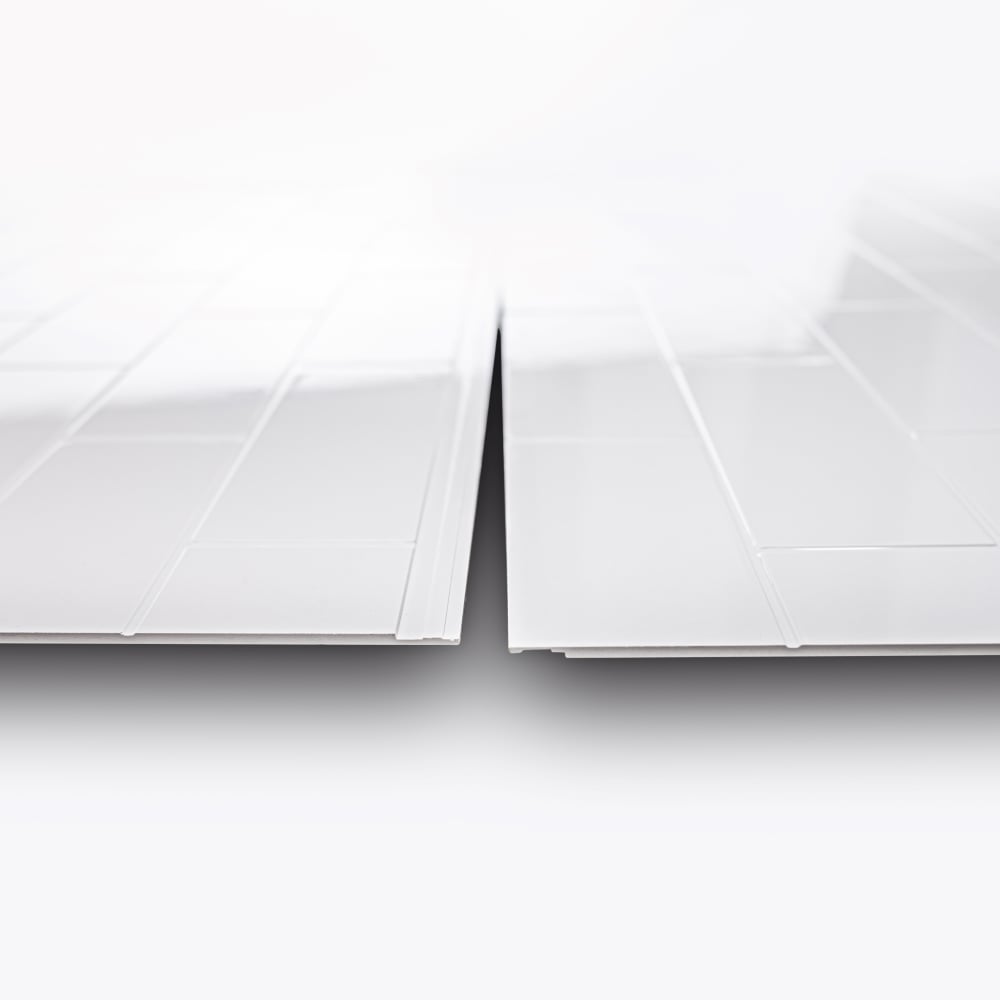Close-up of two SMC subway pattern shower wall panels showing the overlapping flange edge profile