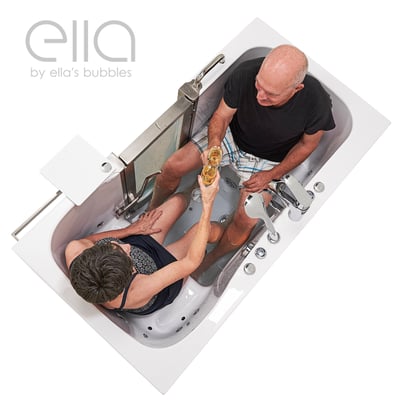 Senior couple toasting with wine glasses together inside the Ella Companion hydro walk-in tub with dual drain