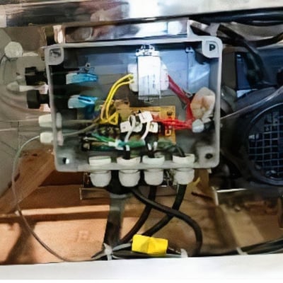 Close-up of an Ella walk-in tub internal junction box with color-coded wiring and electrical components