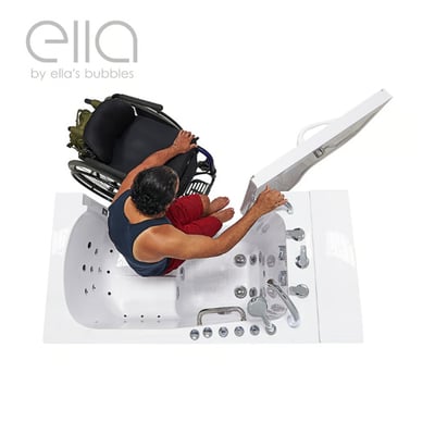 Wheelchair user transferring sideways from wheelchair into an Ella walk-in tub with hydro air jets and open outward swing door