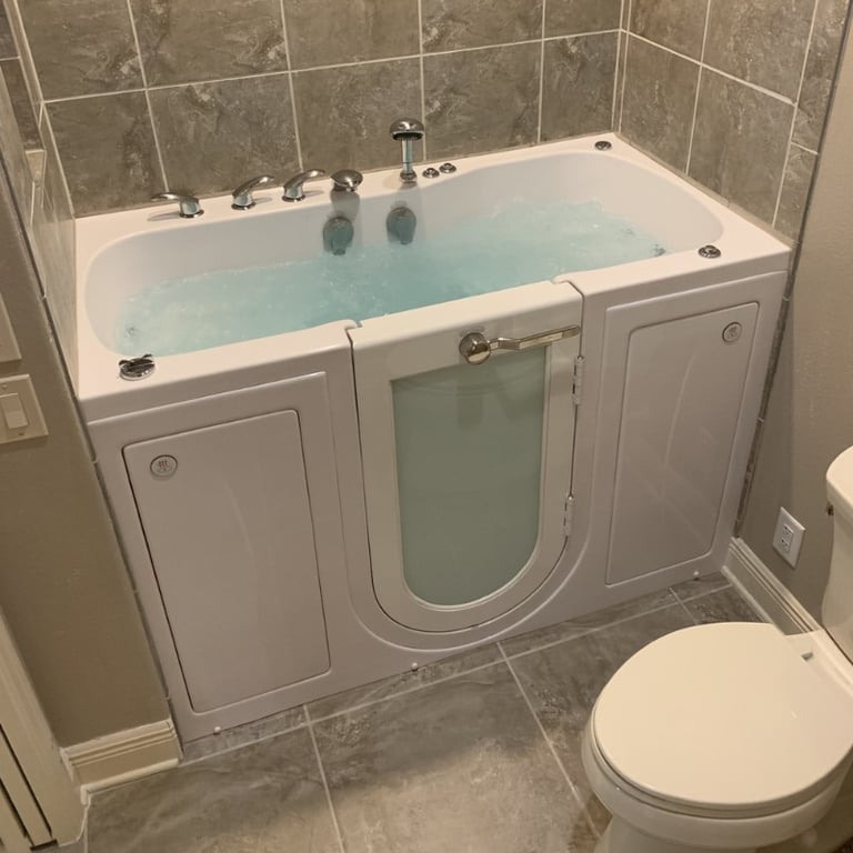 Ella walk-in tub filled with water and active jets installed in a tiled bathroom with chrome faucet fixtures