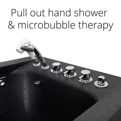 Close-up of chrome control knobs and pull-out hand shower on a black walk-in tub deck with microbubble therapy system