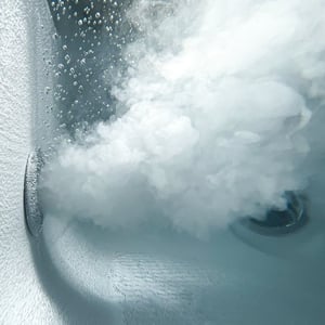 Close-up of powerful microbubble air jets creating foamy turbulence inside the Ella Royal acrylic walk-in tub
