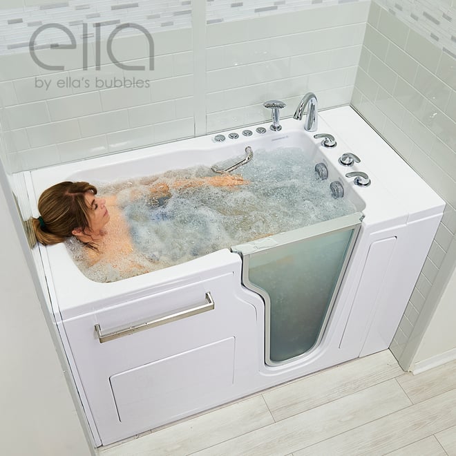 Woman relaxing with eyes closed enjoying a bubbling hydro massage in the Ella Ultra walk-in tub with dual drain technology