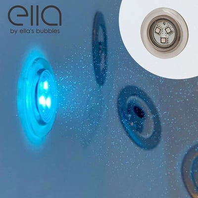 Close-up of glowing blue chromotherapy LED light inside an Ella's Bubbles walk-in tub with air jet ports visible