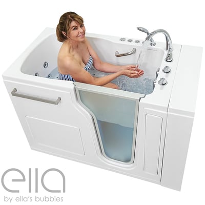 Woman smiling and testing warm running water from chrome faucet while seated in an Ella Ultra walk-in tub with hydro jets