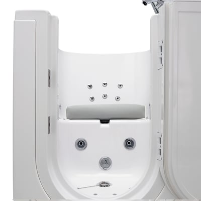 Front view of an Ella walk-in tub interior showing seat pillow riser, hydro jets, drain, and chrome faucet fixtures
