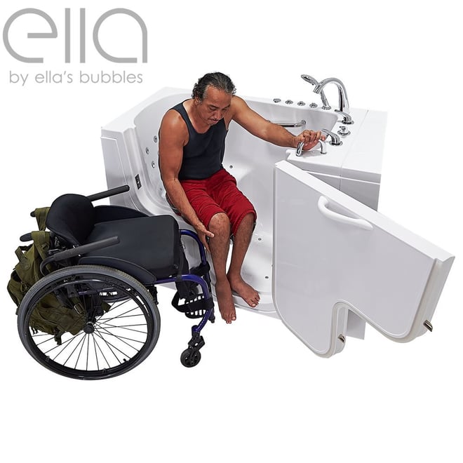 Wheelchair user transferring from blue wheelchair into the Ella Transfer30 walk-in tub with wide outswing door open