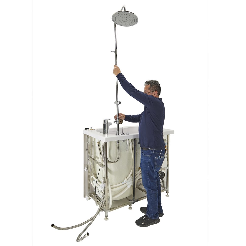 10″ Kit de tête de douche et colonne de douche pour robinets de baignoire encastrés dans le sol - %3E - Installer adjusting a chrome rain shower head on a walk-in tub unit showing the unfinished plumbing and frame structure