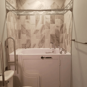 Walk In Tub Reviews Testimonials Feedback 15 White Ella walk-in tub with side door and chrome faucet installed in tiled bathroom with glass shower enclosure and grab bar