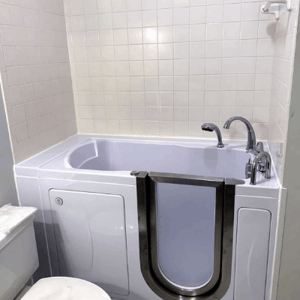 Walk In Tub Reviews Testimonials Feedback 64 White walk-in tub with open inward swing door and chrome faucet installed in a clean tiled bathroom