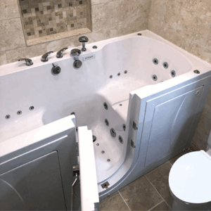 Walk In Tub Reviews Testimonials Feedback 86 White Ella walk-in tub with open inward swing door showing hydrotherapy jets and chrome fixtures in tiled bathroom