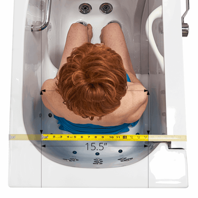 Transfer26 Outward Swing Door Walk-In Tub 26″ x 52″ (66 x 132cm) Dual Drain Technology - Overhead view of woman seated in Ella walk-in tub showing 15.5-inch interior shoulder width measurement with tape measure