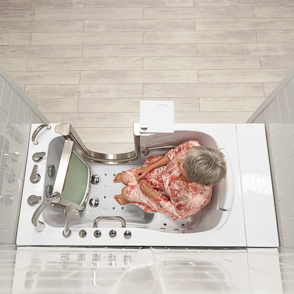 Overhead view of senior woman seated inside an Ella Elite walk-in tub with removable stainless steel door and anti-slip floor