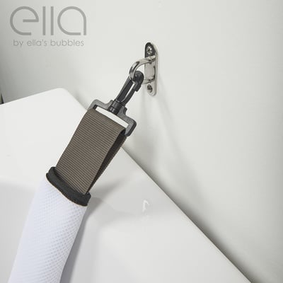 Close-up of Ella's Bubbles walk-in tub seat belt strap with stainless steel wall-mounted swivel clip for safety support