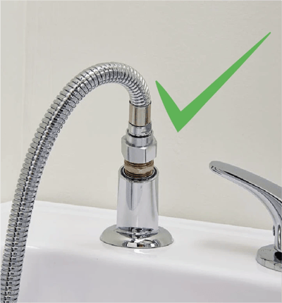 Leak Elimination Kit for Pull Out Hand Showers (5′ Hose with Barrel Connector) - Close-up of chrome handheld showerhead hose and faucet mounted on a walk-in tub deck with a green checkmark approval icon