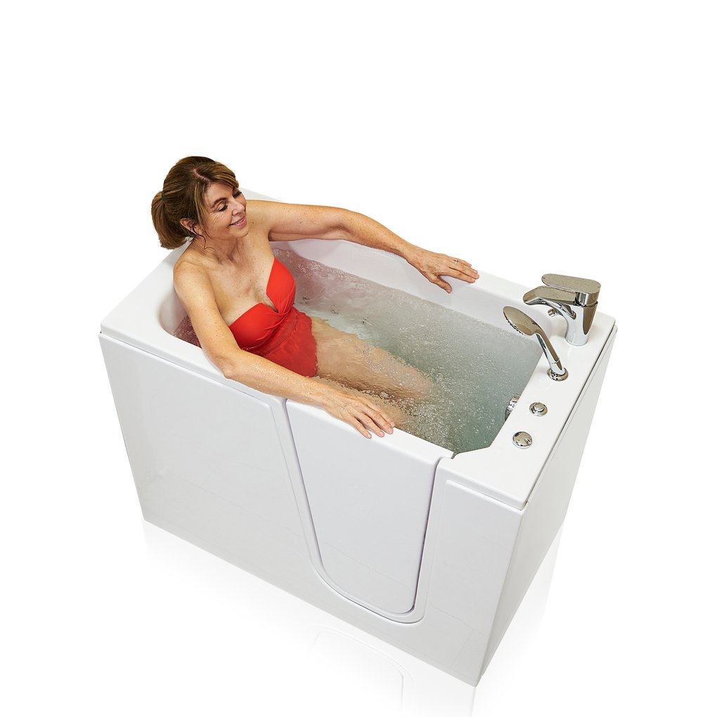 Woman in red swimsuit smiling and relaxing in the Ella Flow walk-in tub during a hydro therapy massage soak