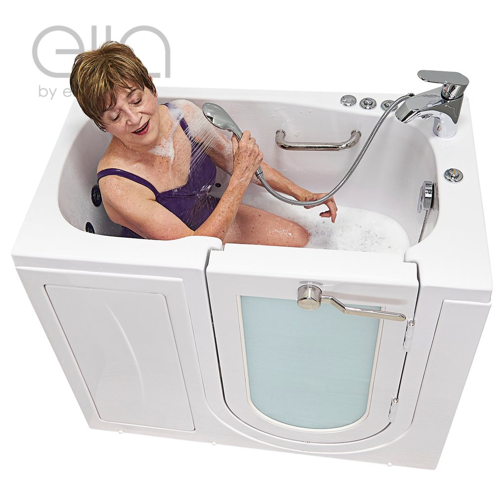 Senior woman using a handheld showerhead while seated in the Ella Mobile walk-in tub with outward swing door